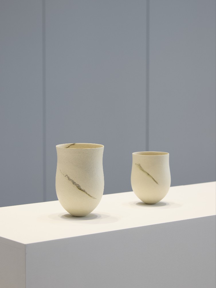Displayed together are Jennifer Lee’s works from 2001 and 1998, both created using similar clays and traditional hand-building techniques.